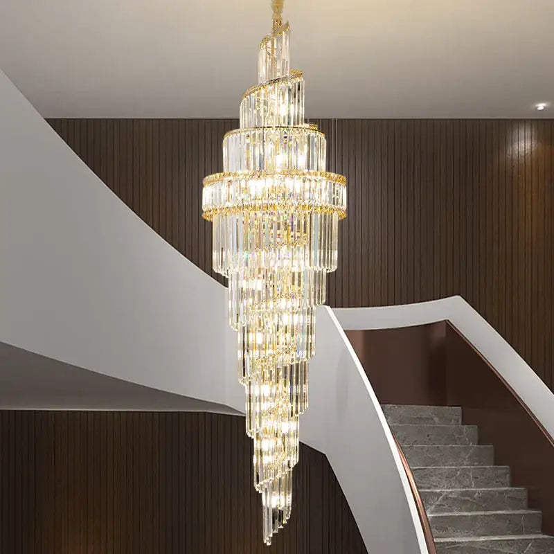 Modern gold crystal hollow chandelier with cascading light and gold accents elegantly hangs above staircase decorbites crystal hollow
