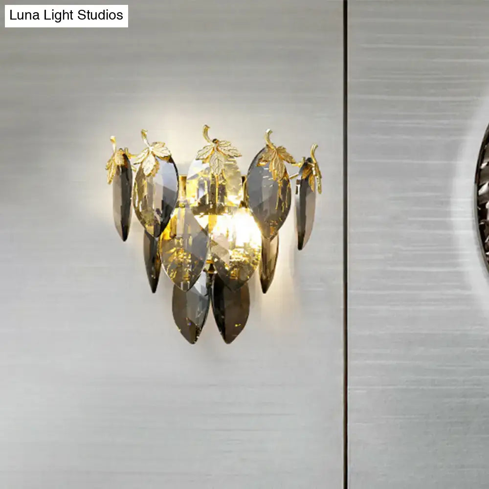 Elegant gold-toned wall lamp with cascading dark gray and clear crystal leaves compatible with led incandescent fluorescent bulb base