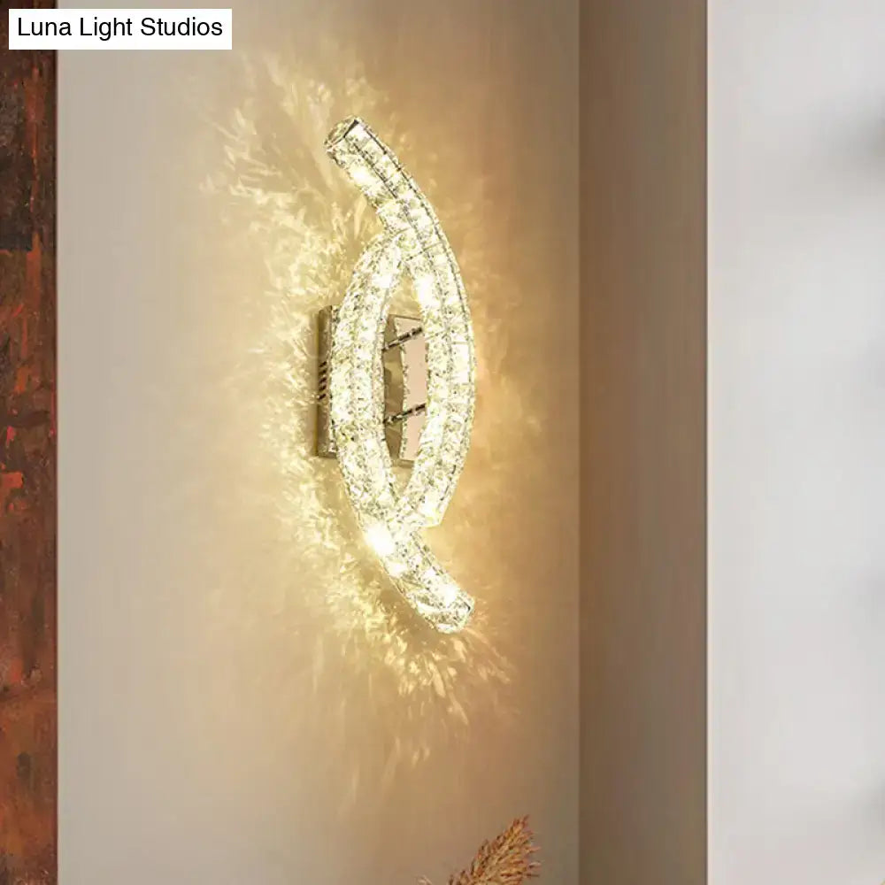 Modern gold crystal leaf wall light with chrome finish and clear crystals refracting warm light for crystal living room