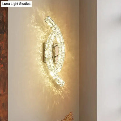 Modern gold crystal leaf wall light with chrome finish and clear crystals refracting warm light for crystal living room