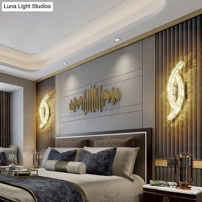 Modern gold-toned metallic cityscape leaf wall light with crystal design for elegant living room sconce decor