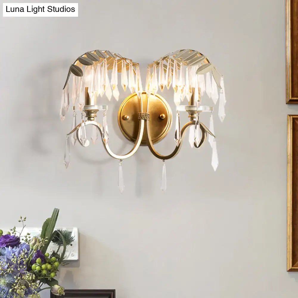 Modern gold crystal leaf wall sconce light with bent arm and dangling crystal droplets for bedroom lighting