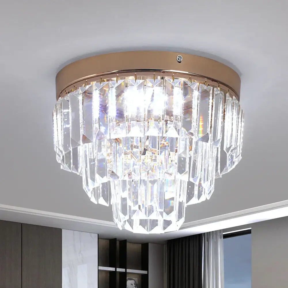 Modern gold crystal led ceiling chandelier with rose gold base and cascading clear faceted glass prisms for dining room