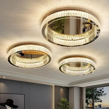 Three elegant gold crystal led ceiling chandeliers with circular frames and faceted glass for living room lighting