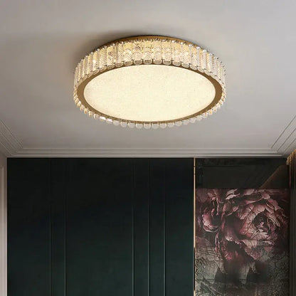 Modern gold crystal led ceiling light with a gold metal frame, clear faceted crystals, and frosted glass center for bedroom decorbites crystal led