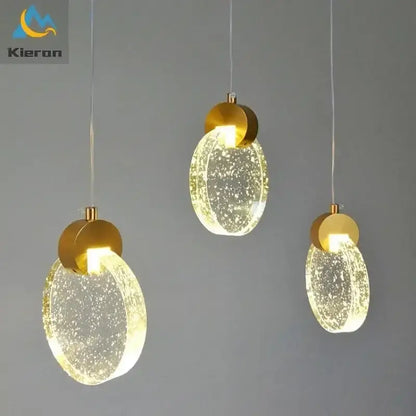Three modern gold crystal led chandelier pendant lights with bubble-filled glass shades from decorbites crystal led collection