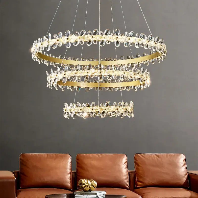 A modern gold crystal led chandelier with three-tiered metal rings and clear crystal droplets for dining room decorbites crystal led