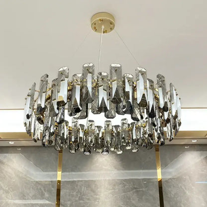 Modern gold crystal led chandelier with faceted crystal prisms suspended from gold-toned mount by Decorbites crystal led