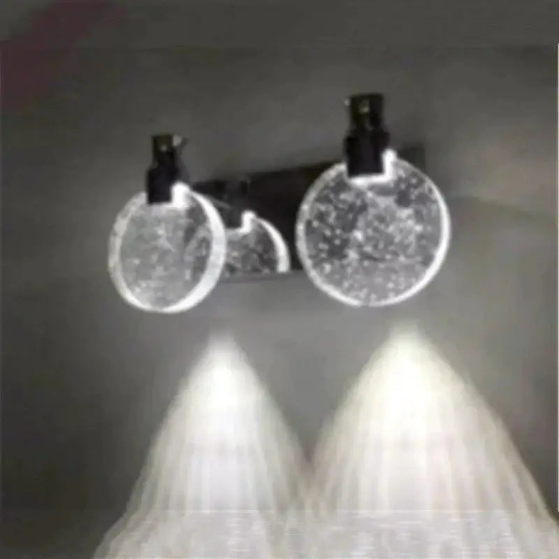 Modern gold crystal led wall lamp with clear circular textured glass and black clips for bathroom lighting