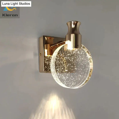 Modern gold crystal led wall lamp with a simple crystal led globe filled with sparkling particles for bathroom use