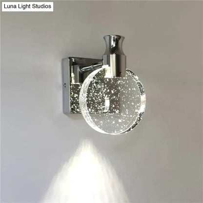 Modern gold crystal led wall lamp featuring a chrome finish and clear circular glass globe with white speckles