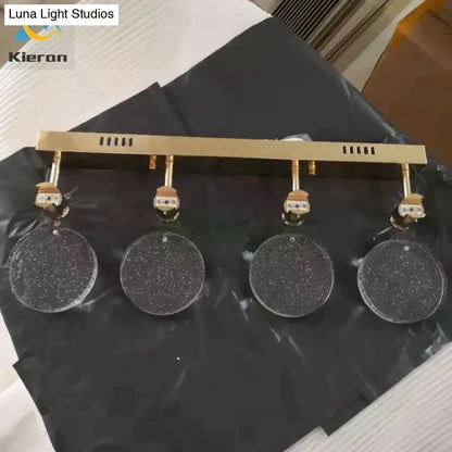 Modern gold crystal led wall lamp featuring a gold-toned four-light track with clear speckled crystal led shades