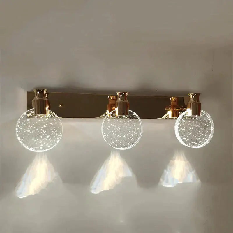 Modern gold crystal led wall lamp with three circular glass globes filled with sparkling particles for bathroom use