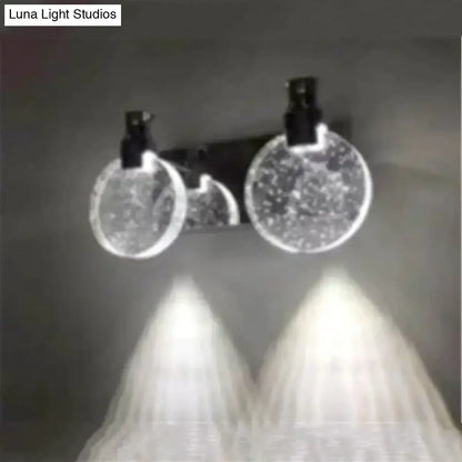 A modern gold crystal led wall lamp with three globe light and simple crystal led bubble glass diffusers in black fixtures