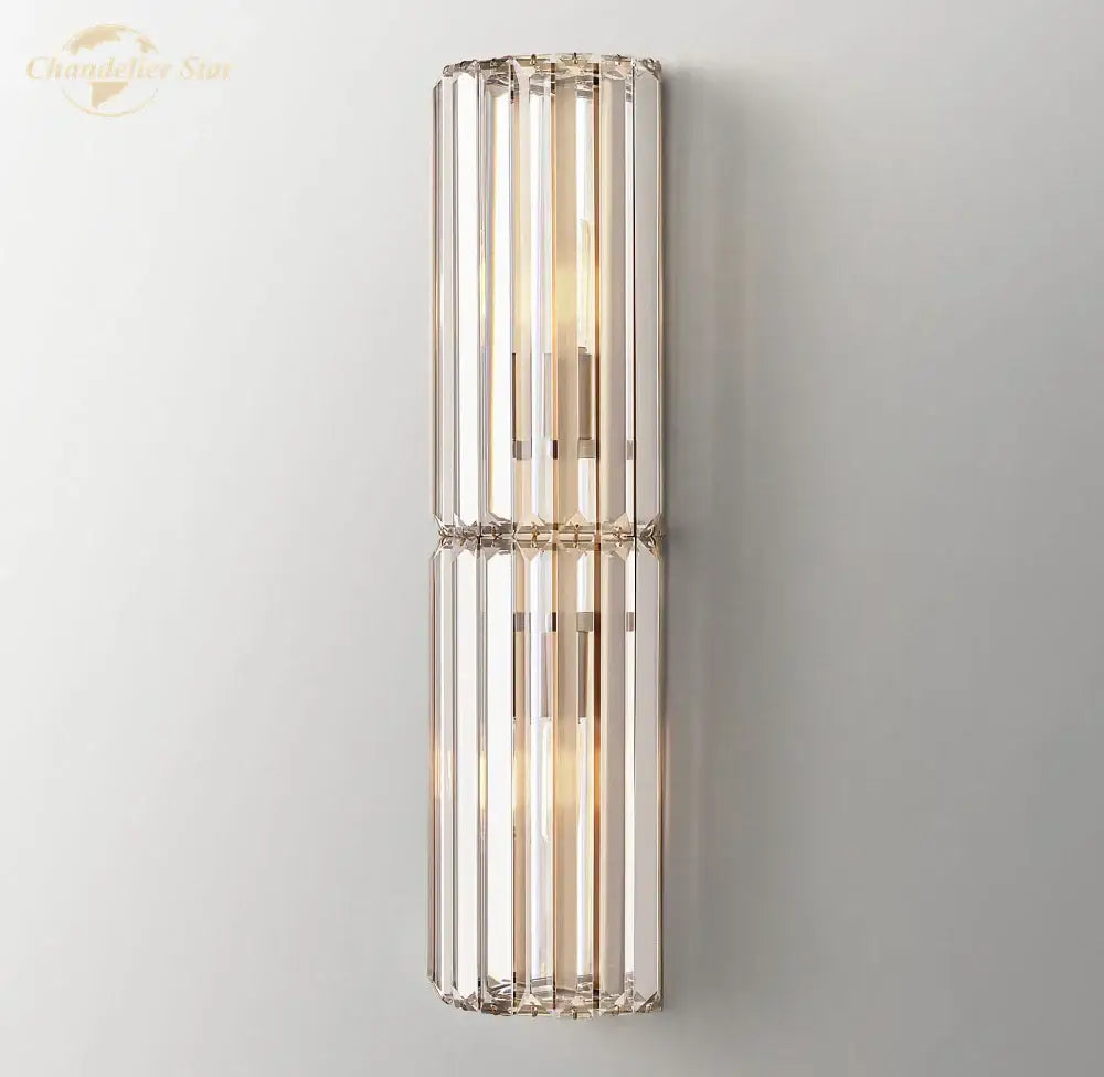 Modern gold crystal led wall sconce with vertical crystal rods and metallic frame for warm bedroom lighting decorbites crystal led