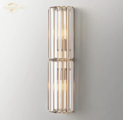 Modern gold crystal led wall sconce with vertical crystal rods and metallic frame for warm bedroom lighting decorbites crystal led