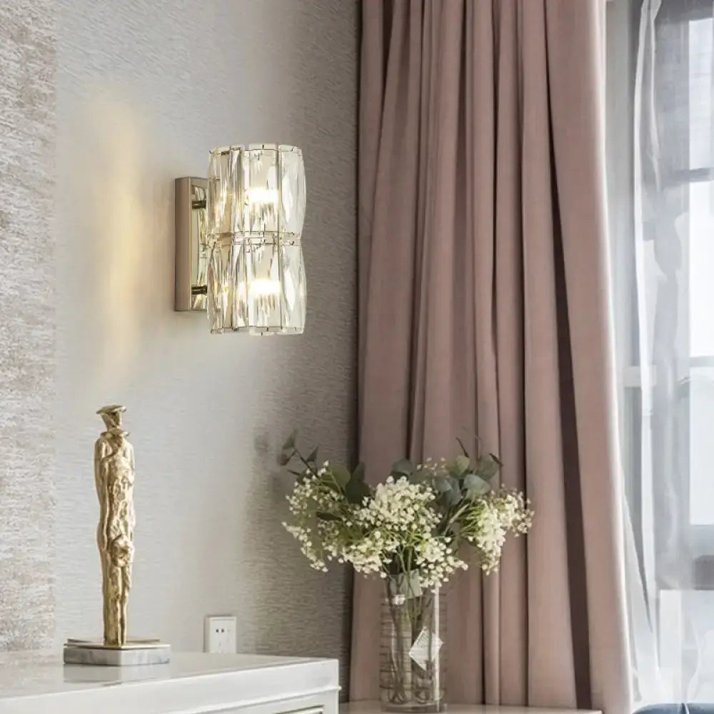 Modern gold-toned crystal linear wall light with faceted glass elements designed for dining room use