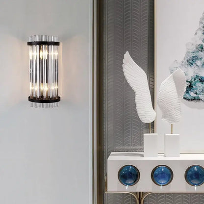 Modern gold crystal luxury wall lamp with vertical crystal tubes and black metal frame for elegant bedroom decorbites crystal luxury wall