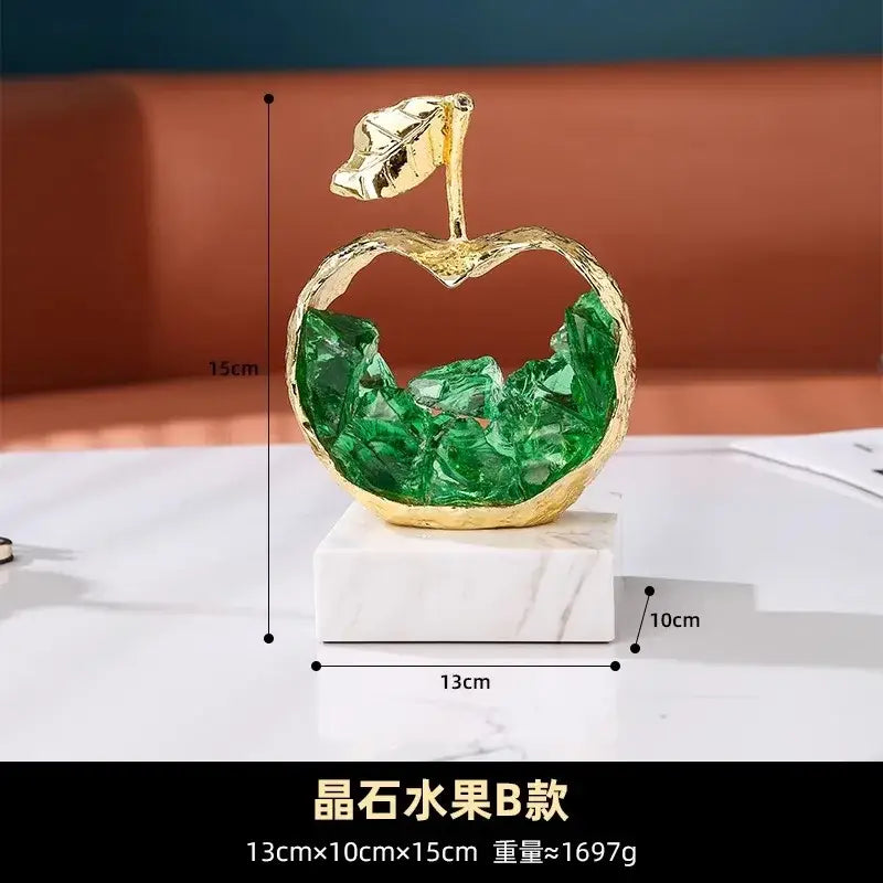 Modern gold crystal metal fruit sculpture set featuring a hollow apple with green stones on marble base for living room decor