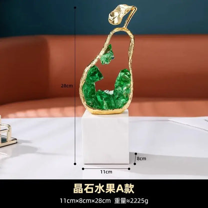 Modern gold crystal metal fruit sculpture set featuring a golden pear with green crystal interior and leaf decor on marble base