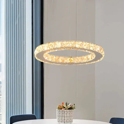 A modern gold crystal möbius strip pendant chandelier with faceted crystals warm glow for dining room decorbites gold