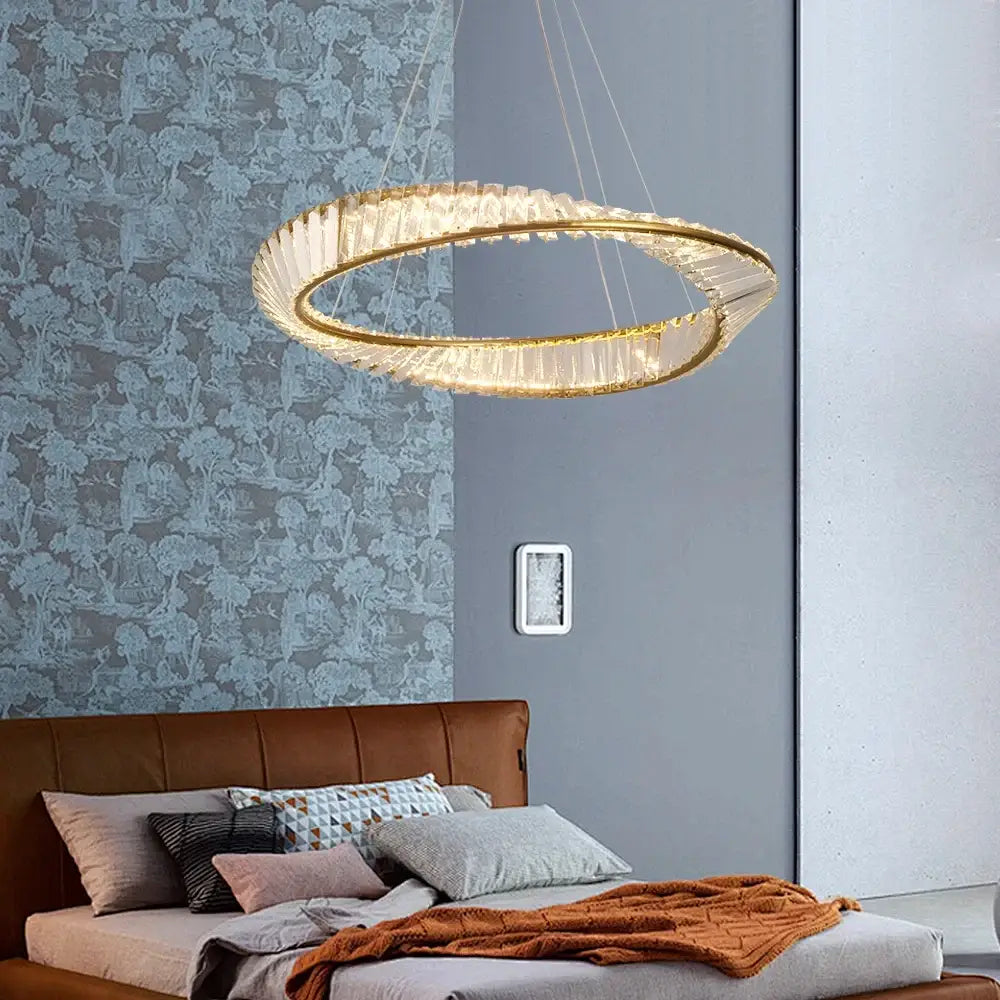 Modern gold crystal möbius strip pendant chandelier with gold-toned double-ring and faceted crystal accents decorbites gold