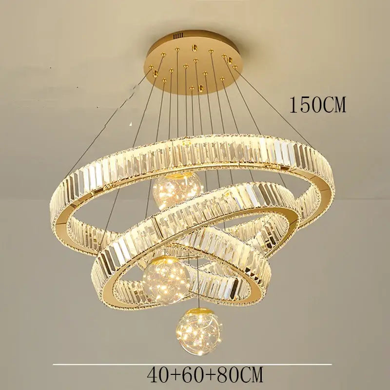 Modern gold crystal pendant light with three interlocking rings and brushed stainless finish for dining room use