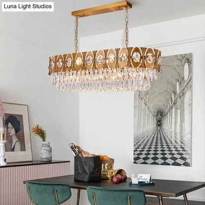 Modern gold crystal oval suspension island pendant light with gold-toned rectangular frame and crystal droplets