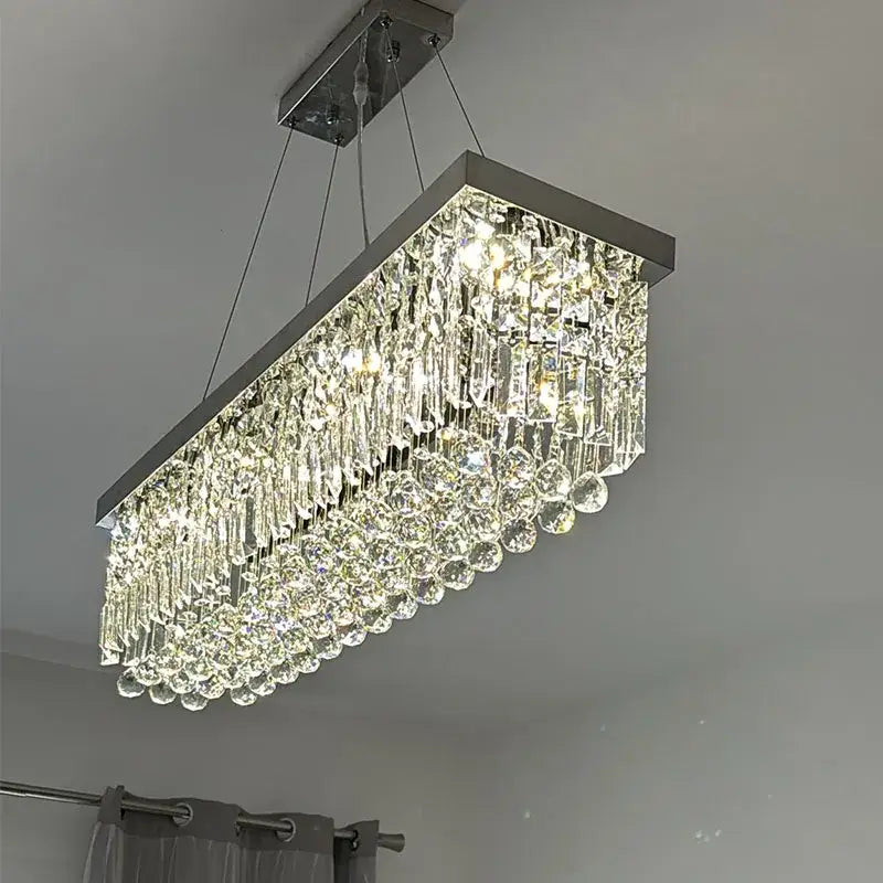 Modern gold crystal pendant light rectangular chandelier with a sleek chrome frame and cascading clear glass prisms