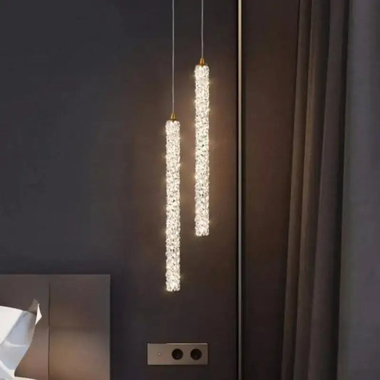 Two elegant gold crystal pendant lights with illuminated faceted glass elements for luxury dining room decorbites chandelier