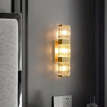 Modern gold crystal rectangle wall lamp featuring textured stacked glass panels emitting a warm glow for luxury decorbites crystal rectangle lighting