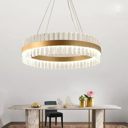 Modern gold crystal ring chandelier with a metal frame and vertical crystal prisms for elegant dining room lighting