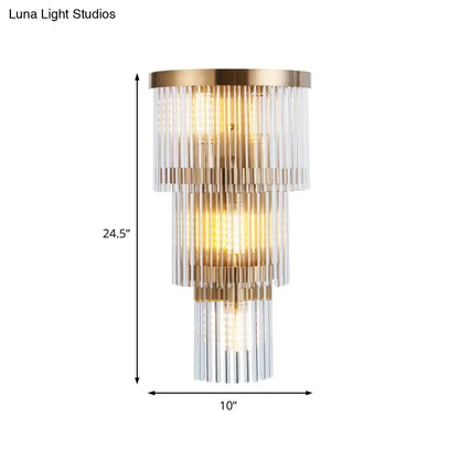 Modern gold crystal rod tiered wall lamp with three cascading levels of clear glass rods in a brushed brass frame