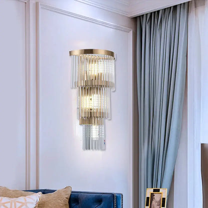 Modern gold wall lamp with crystal rod tiers and clear glass cascades ideal for dining room lighting