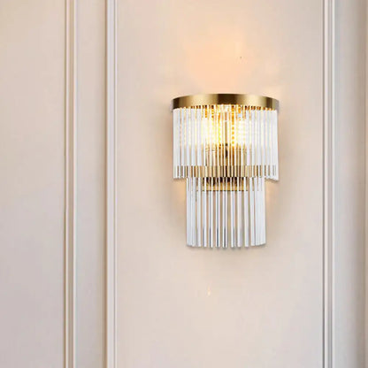 Modern gold wall lamp with cascading clear crystal rods for elegant dining room lighting