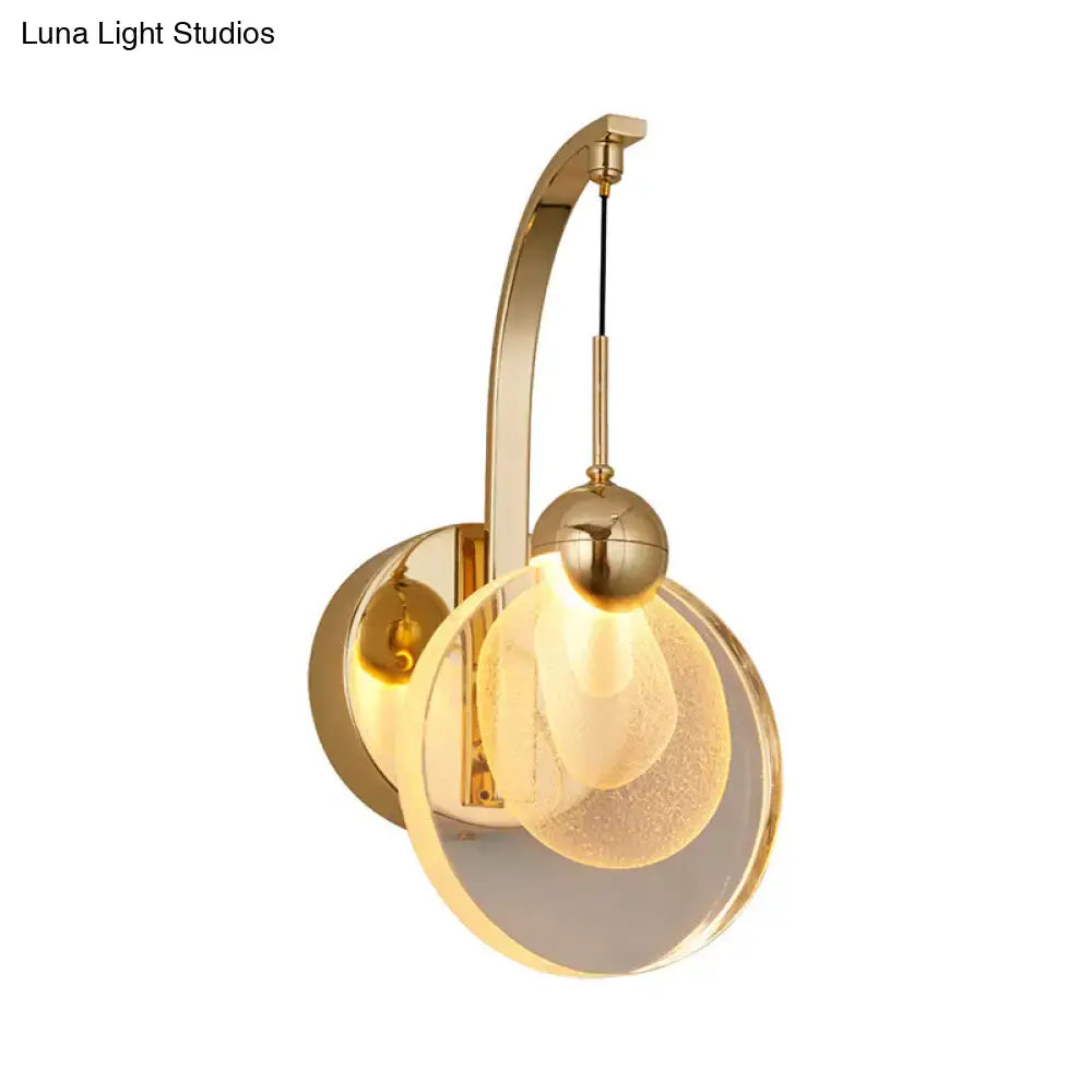 Modern gold wall lamp with curved metal arm and illuminated frosted crystal shade suitable for 110v-120v and 220v-240v use