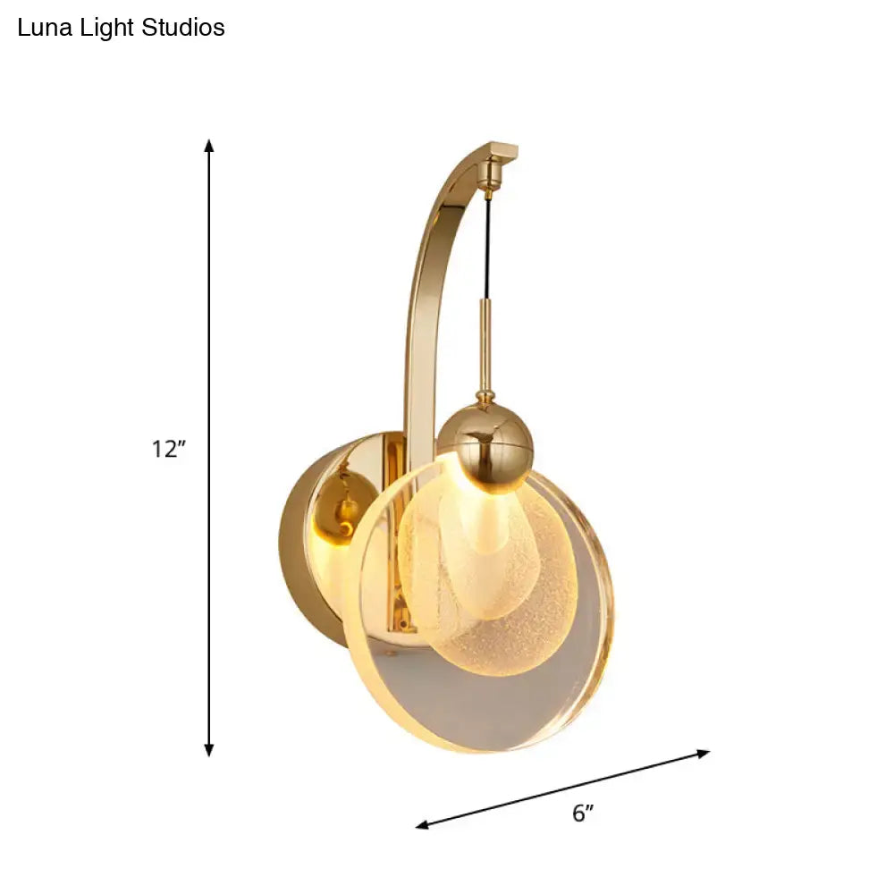 Gold-toned wall lamp with crystal shade featuring a curved arm and illuminated frosted glass globe for 110v-120v use