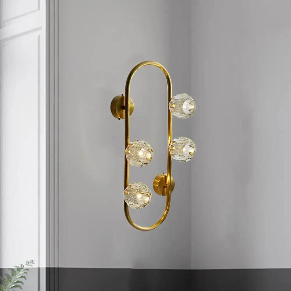 Modern gold wall lamp with five faceted crystal shade globes on a curved frame direct wired electric fixture