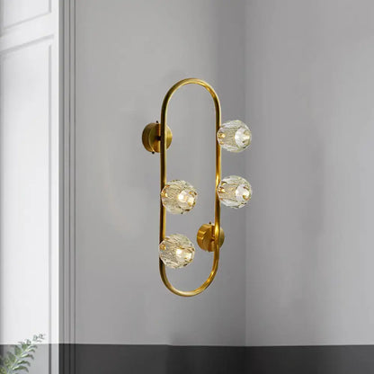 Modern gold wall lamp with five faceted crystal shade globes on a curved frame direct wired electric fixture