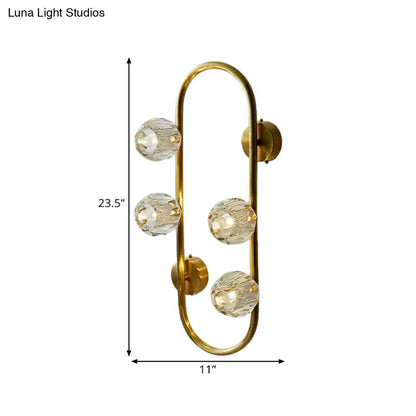 Modern gold wall lamp with crystal shade and four faceted globe bulbs in a direct wired electric design