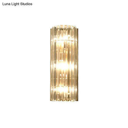 Modern gold crystal shade wall scone with vertical crystal rods and warm led incandescent fluorescent glow for living room