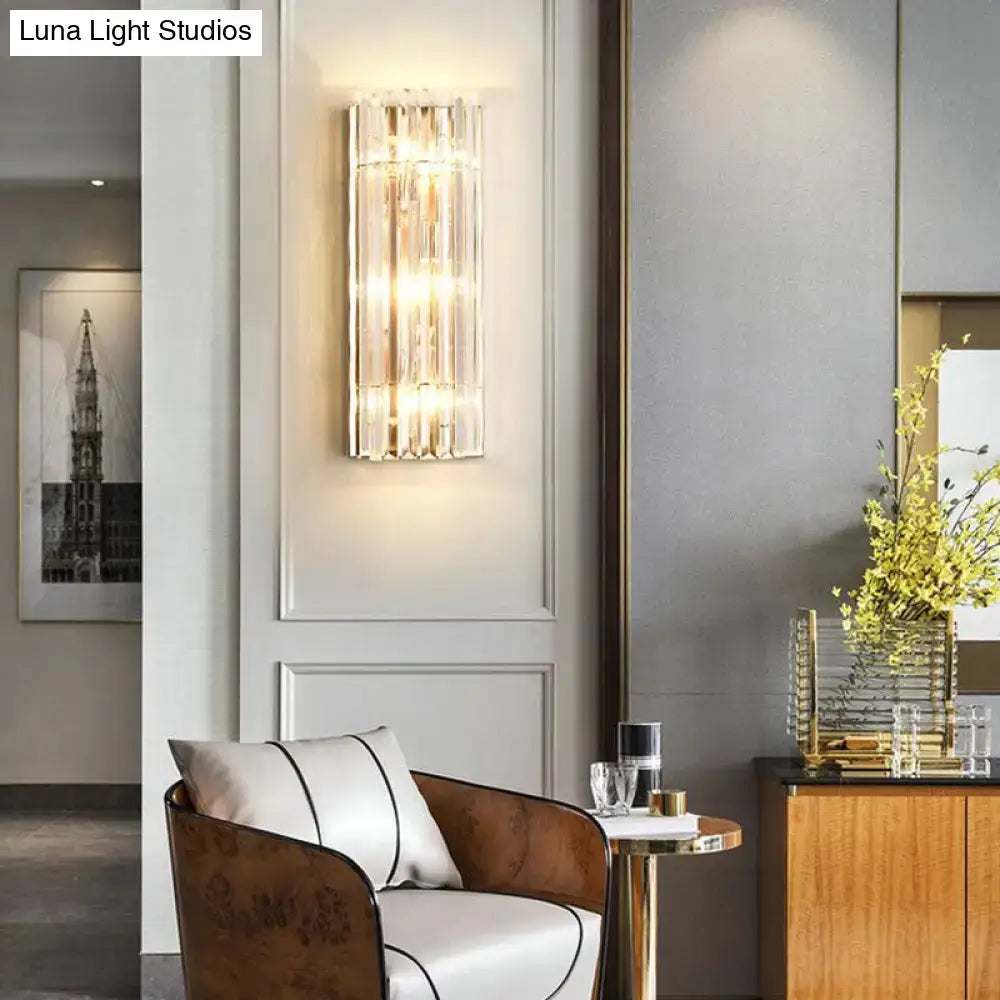 Elegant modern gold wall scone with vertical crystal shade rods and warm led incandescent light for living room use