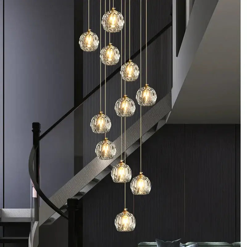 Modern gold crystal stair football shaped chandelier with multiple faceted crystal globe lights suspended by chains