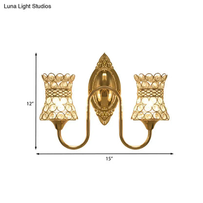 Modern gold crystal swirl wall sconce with two crystal-encrusted lampshades and ornate gold-toned central plate