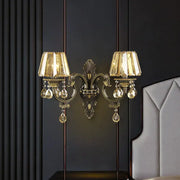Modern gold crystal teardrop living room wall sconce with ornate design and two crystal-encrusted lampshades
