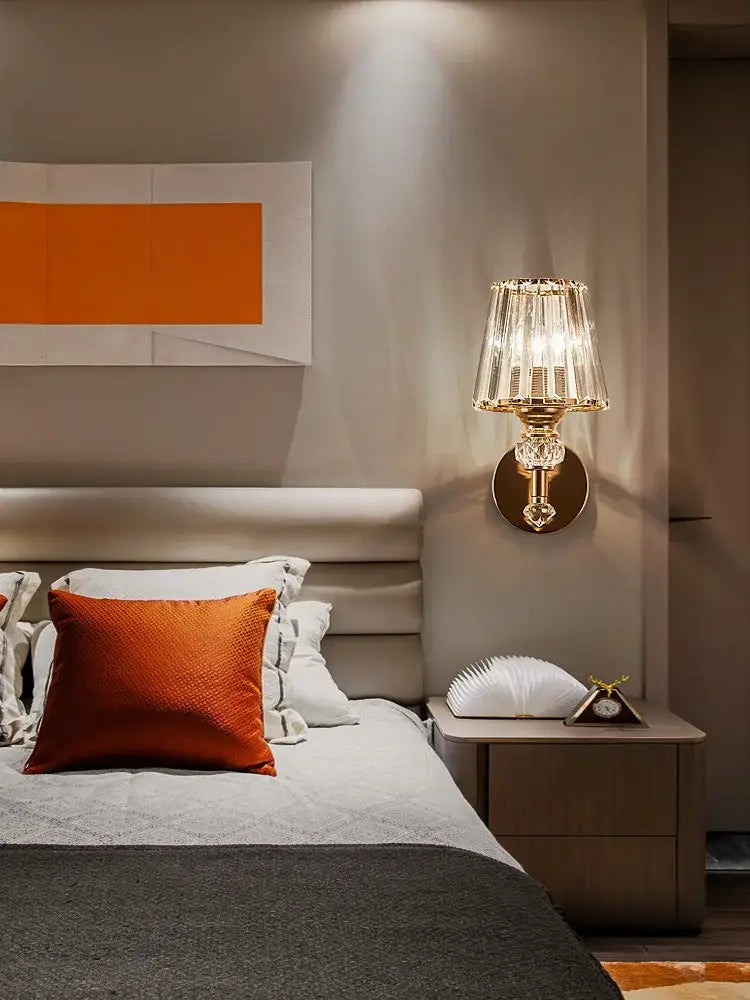 Modern gold crystal wall lamp featuring a faceted crystal shade for elegant bedroom decorbites crystal wall lighting