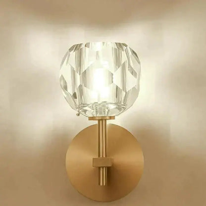 Decorbites ivy crystal wall lamp with faceted crystal globe on brushed brass stem and circular backplate wall lamp