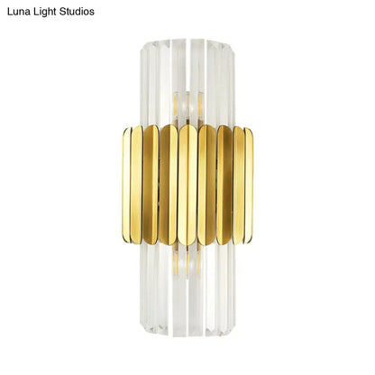 Modern gold crystal wall lamp featuring clear faceted crystal body with vertical ridges and horizontal gold bands for bedroom use