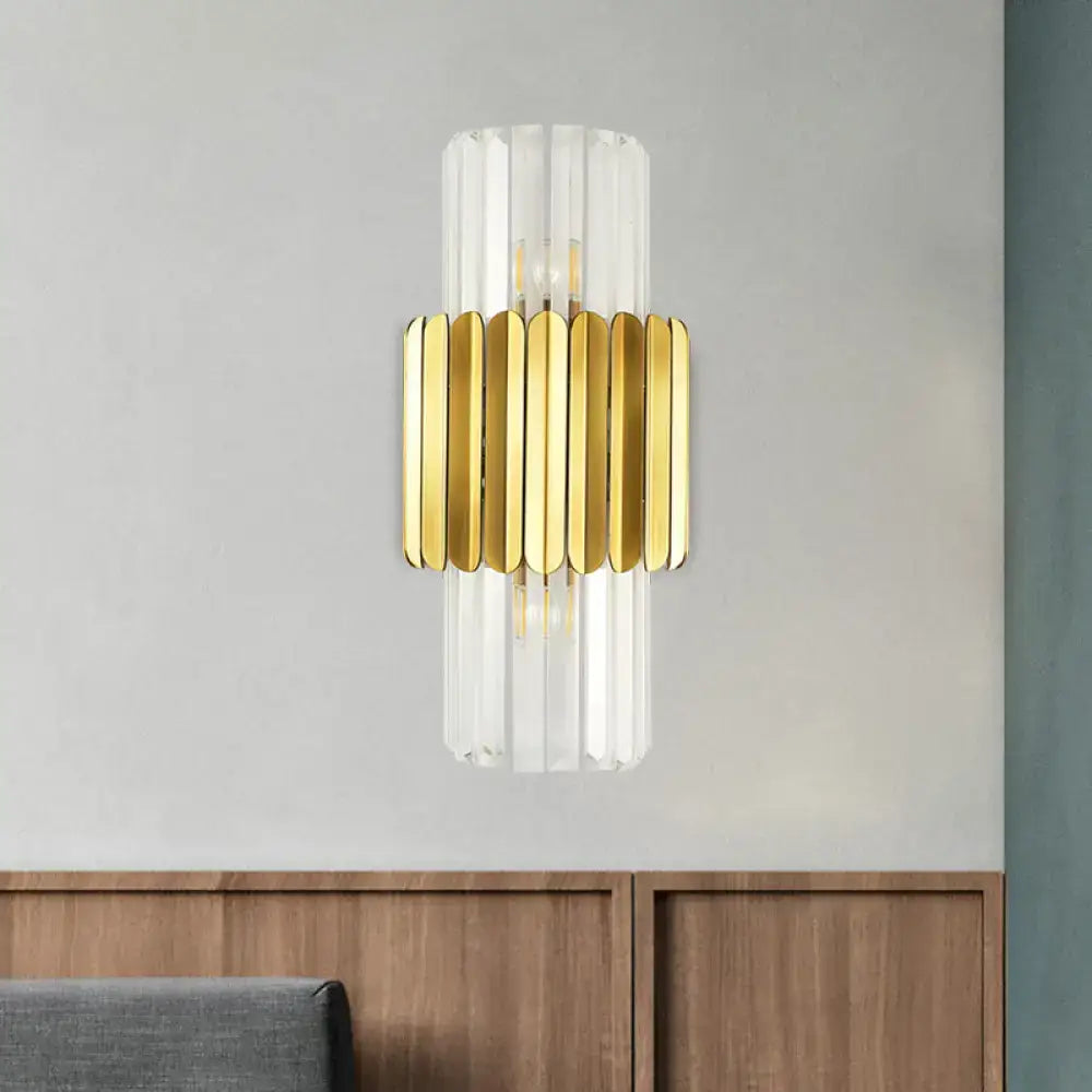 Modern gold crystal wall lamp with clear glass cylinder and gold-toned metallic slats for bedroom sconce lighting