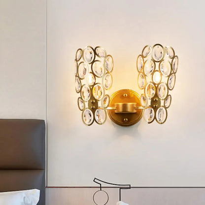 Modern gold crystal wall lamp bedroom sconce featuring cascading clear crystal discs in a gold-toned finish
